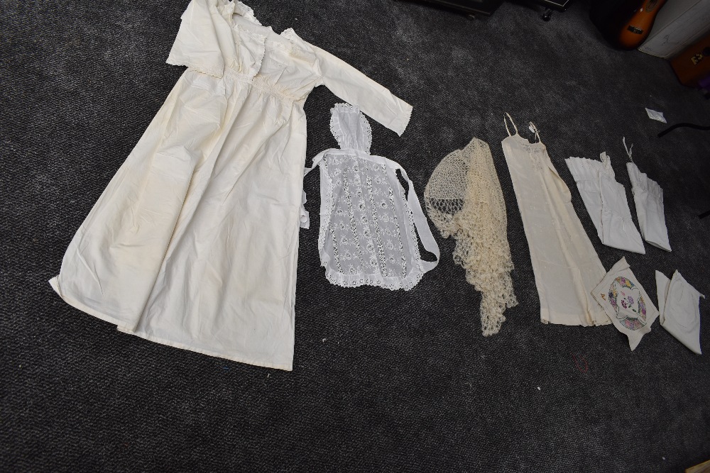 A mixed lot of vintage and antique underwear, aprons and more also included is a Victorian