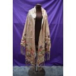A beautiful antique silk shawl having bright floral design and deep fringed edge, very fragile but