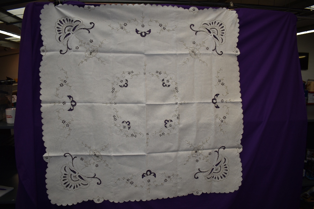 A vintage linen table cloth and napkins with cut work and embroidery.