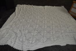 An antique white knitted bed spread,approx 108' X 70'.