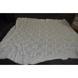 An antique white knitted bed spread,approx 108' X 70'.