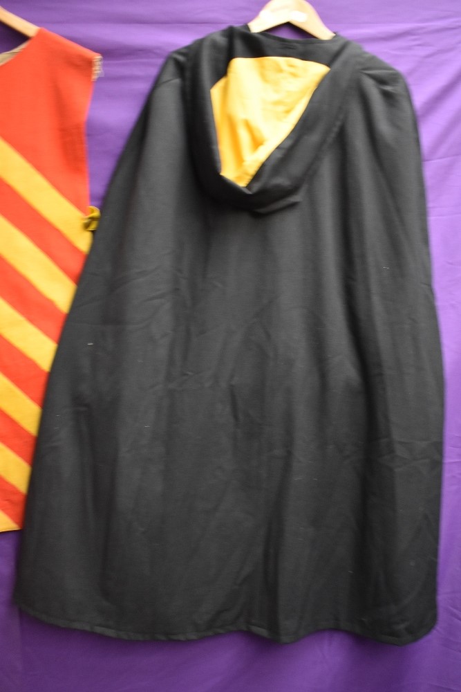 A 1970s black cape having yellow lining and a red and yellow fancy dress tabbard, around 1930s. - Image 3 of 3