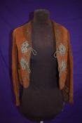 An early 20th century tan Nubuck jacket having extensive and intricate metal thread and braid