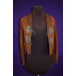 An early 20th century tan Nubuck jacket having extensive and intricate metal thread and braid