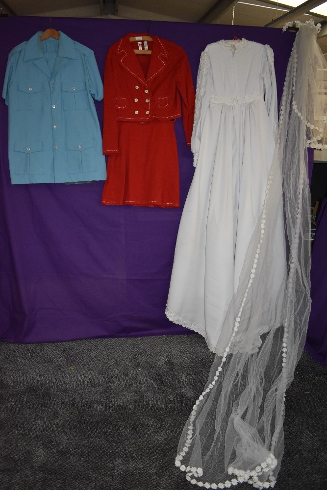 A mixture of ladies vintage clothing including wedding dress.
