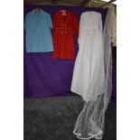 A mixture of ladies vintage clothing including wedding dress.