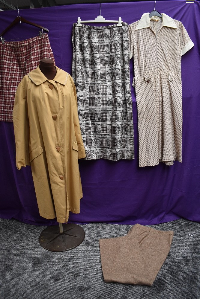 A collection of ladies vintage clothing including rain mac and wool skirt.