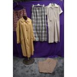 A collection of ladies vintage clothing including rain mac and wool skirt.