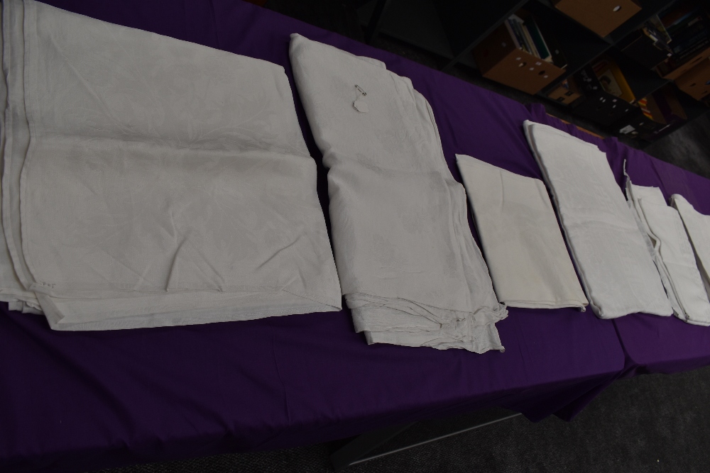 Seven antique damask table cloths.