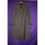 A vintage gents wool/wool blend overcoat having vent to back and pockets to front.