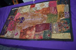 A vintage panel or sampler using panels of various fabrics with embroidery,sequins, braid work and