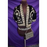 A short velvet bolero or jacket with intricate braid detailing,around 1930s, and a similar bag and