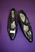 A pair of antique black leather shoes.