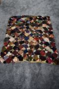 An antique throw or rug using a variety of colourful fabrics.