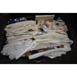 A suitcase containing an assortment of vintage and antique table linen, handkerchiefs, huckaback