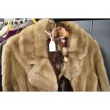 A ladies fur coat and similar stole