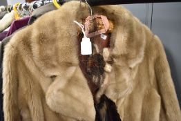 A ladies fur coat and similar stole