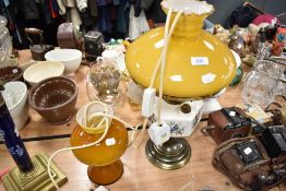 A mid century amber glass mushroom style light and an oil lamp with bird themed well