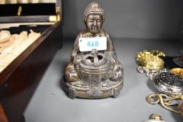 A Chinese style incense burner in the form of a seated Buddha