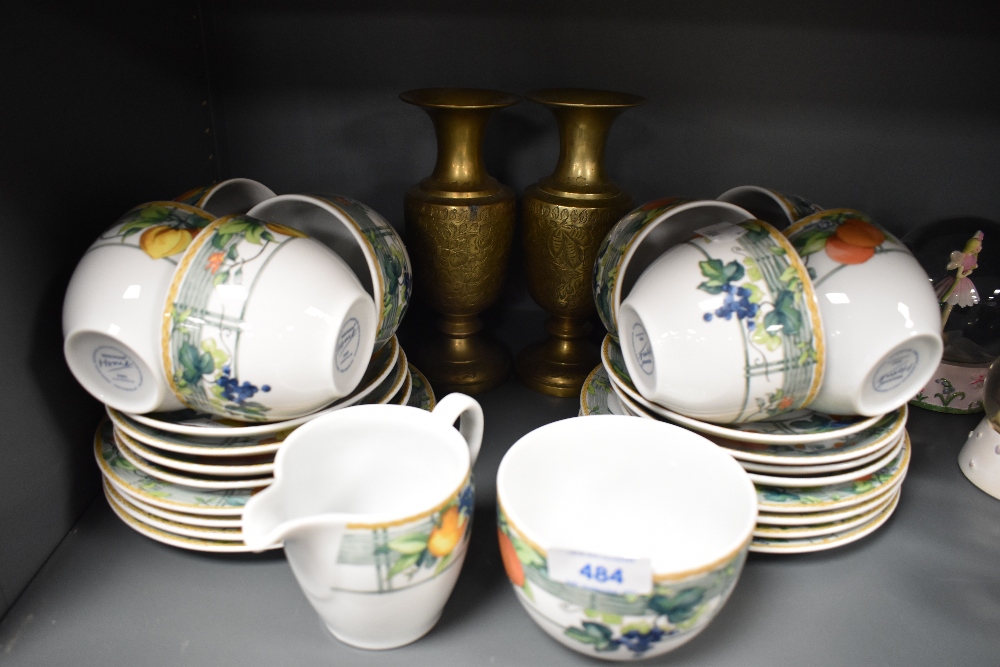A selection of tea cups and saucers by Wedgwood in the Home design and two brass vase