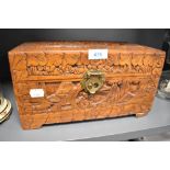 A wooden lidded box having oriental or Chinese carved design