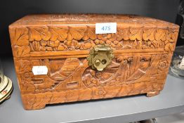 A wooden lidded box having oriental or Chinese carved design