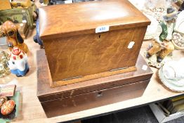 An Edwardian desk top tidy in oak and a similar mahogany writers compendium