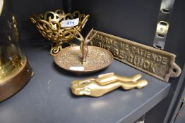 A selection of brass items including a pair of lady leg nut crackers