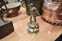 A small bronzed figure of a life boat man approx 10cm tall and a similar enamel badge