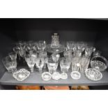 A good selection of crystal clear blown cut and etched glass wares including cocktail and cordial