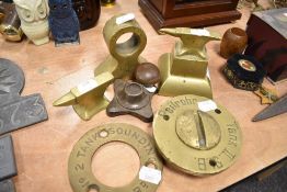 A selection of brass wares including model anvils and industrial valve ends