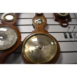 A late Victorian barometer of banjo form with metal face dial and bulls eye mirror