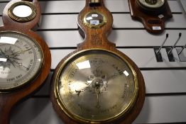 A late Victorian barometer of banjo form with metal face dial and bulls eye mirror