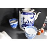 An antique hand decorated porcelain tea pot and two similar tea cups
