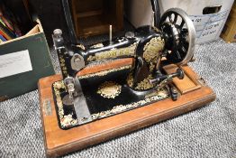 A 1920's English JONES FAMILY C.S. Type 7 Queen Alexandra Sewing Machine with wooden case