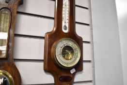 A small mercury barometer with visible mechanism