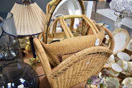 A wicker magazine rack a similar carry bag and an oval framed mirror