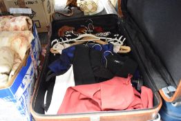 A leather suitcase and selection of ladies clothes