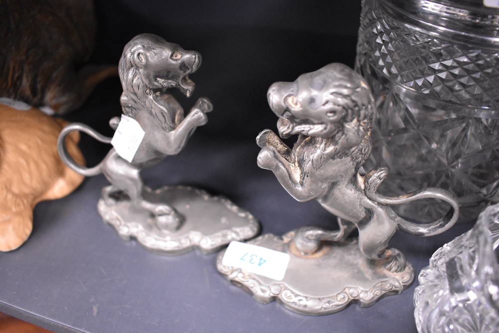 A pair of silver plated rampant lion figures