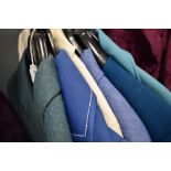 A collection of ladies retro skirt suits and jackets, different colours and styles.