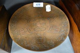 A mid century footed copper dish having native American design by H Alfred