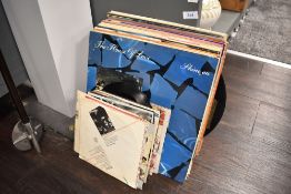 A selection of vinyl albums and 45 rpm singles including eighties interest and big bands