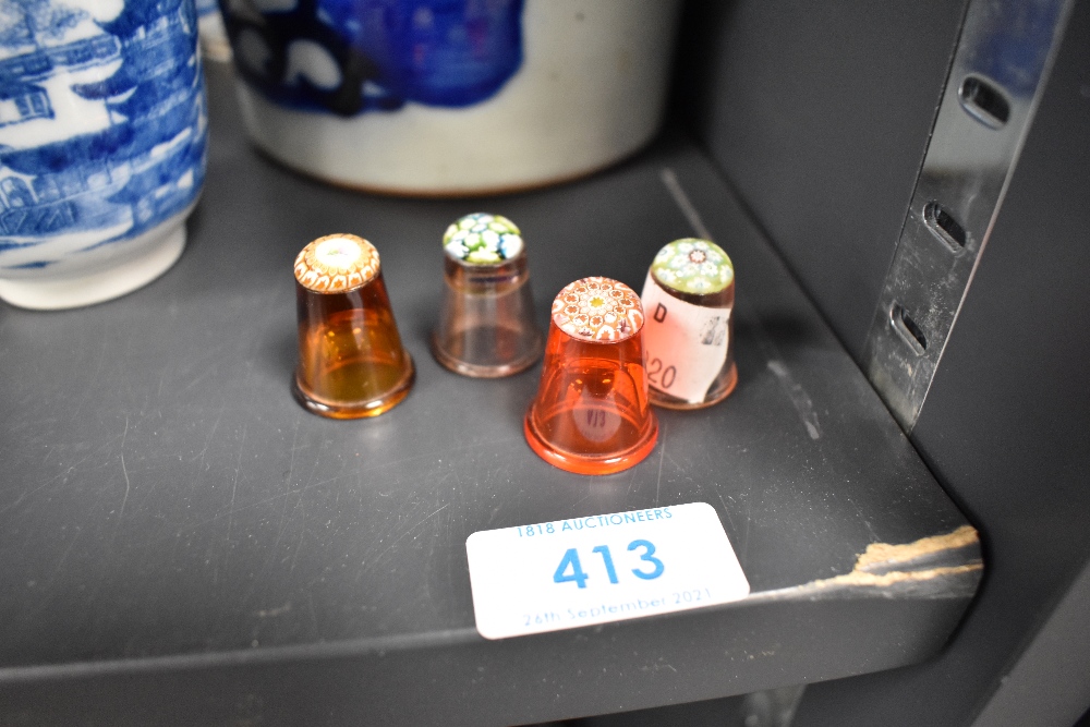 Four glass thimbles having hand worked millefiori designs