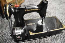 An electric Singer Sewing machine bearing red S badge no model number with case and accessories