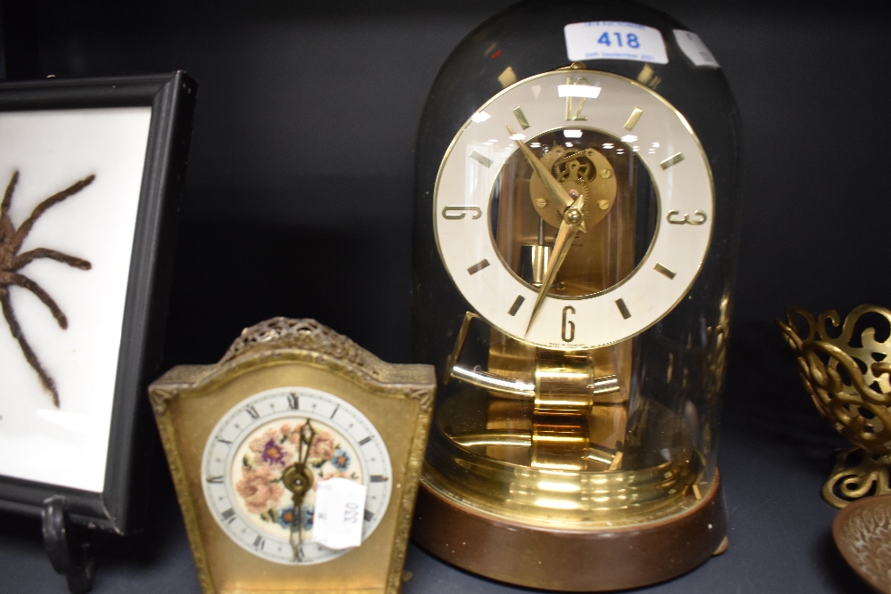 A skeleton style brass anniversary clock by Kundo and similar mantle clock