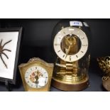 A skeleton style brass anniversary clock by Kundo and similar mantle clock