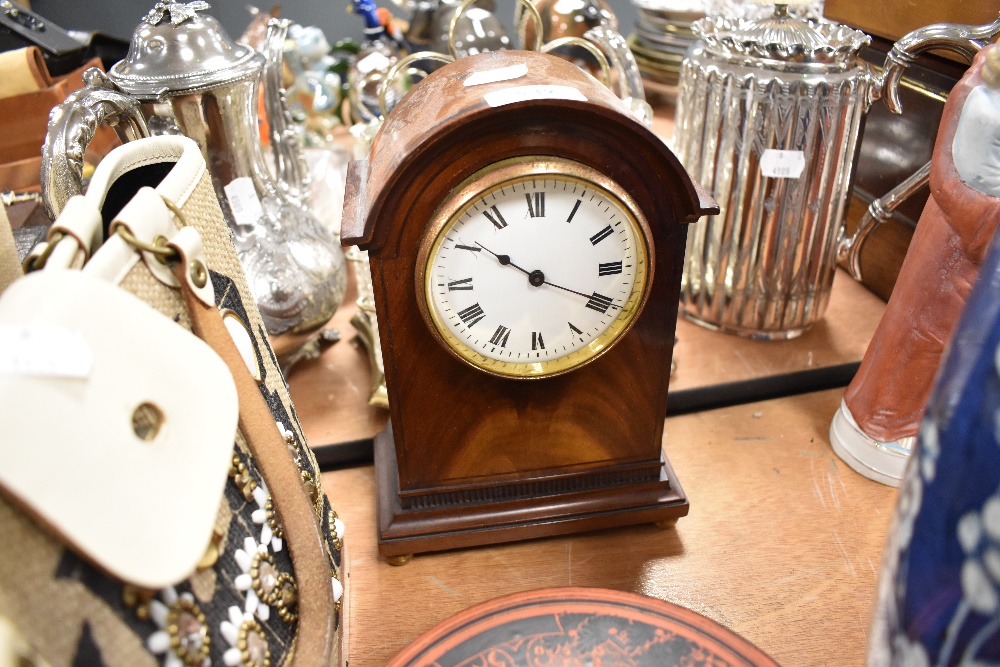 A mahogany cased mantle clock having French movement and enamel face dial