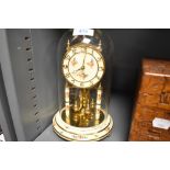 A glass domed anniversary clock by Kundo West Germany