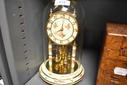 A glass domed anniversary clock by Kundo West Germany