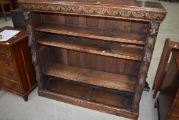 A 19th Century oak bookshelf having carved lunette and lion mask decoration